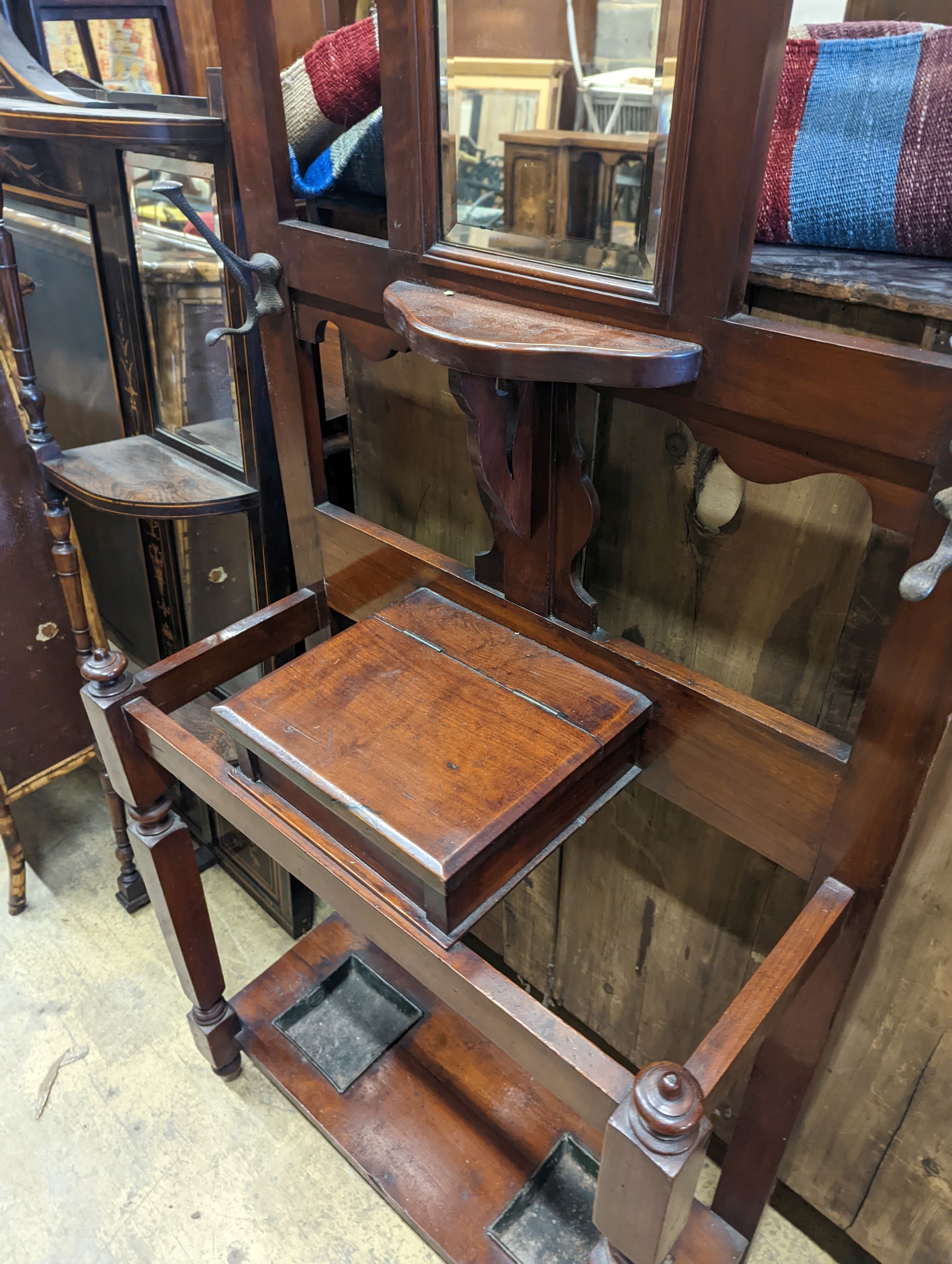 A late Victorian walnut hallstand, length 75cm, depth 30cm, height 203cm